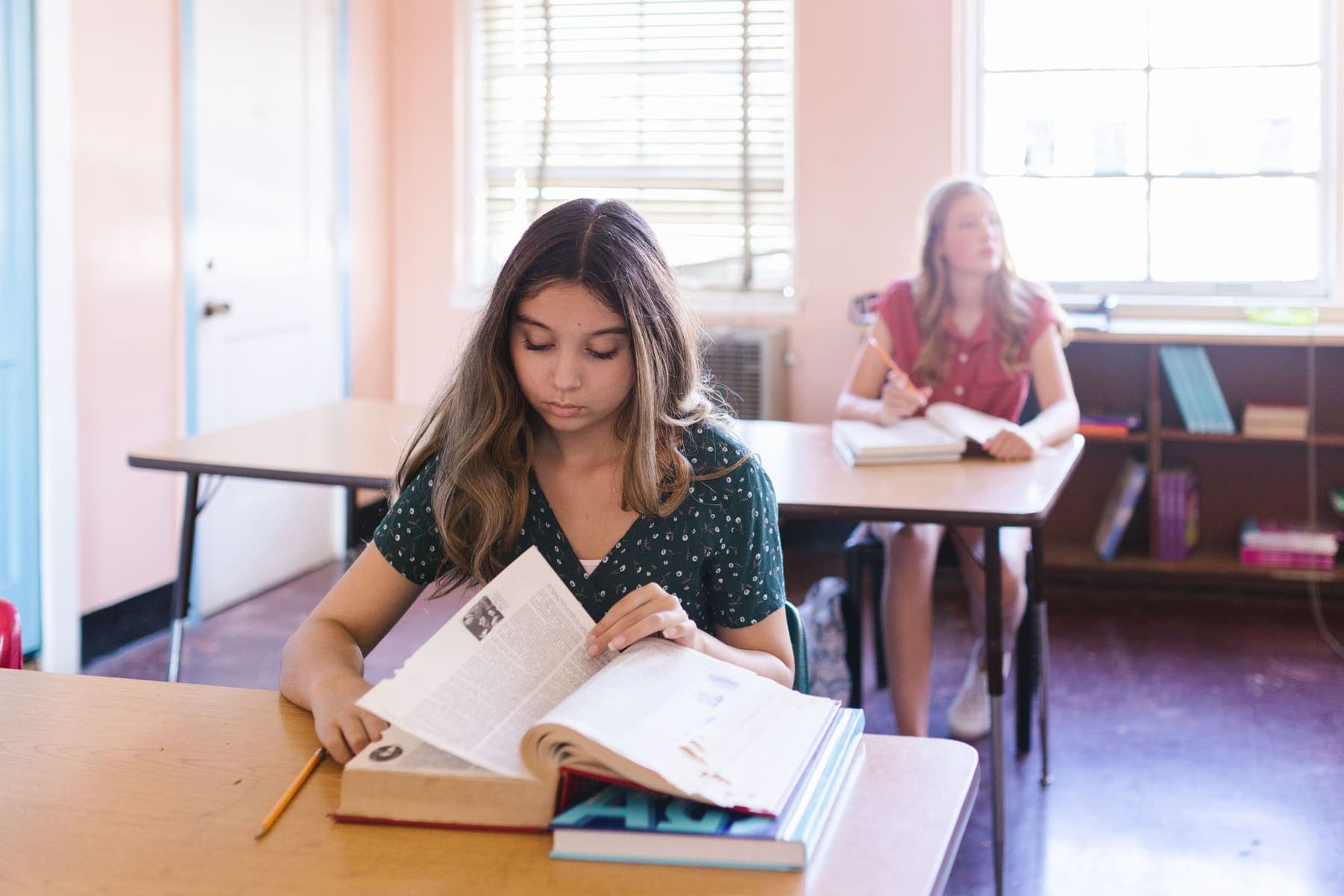 Student reading and taking notes on a text